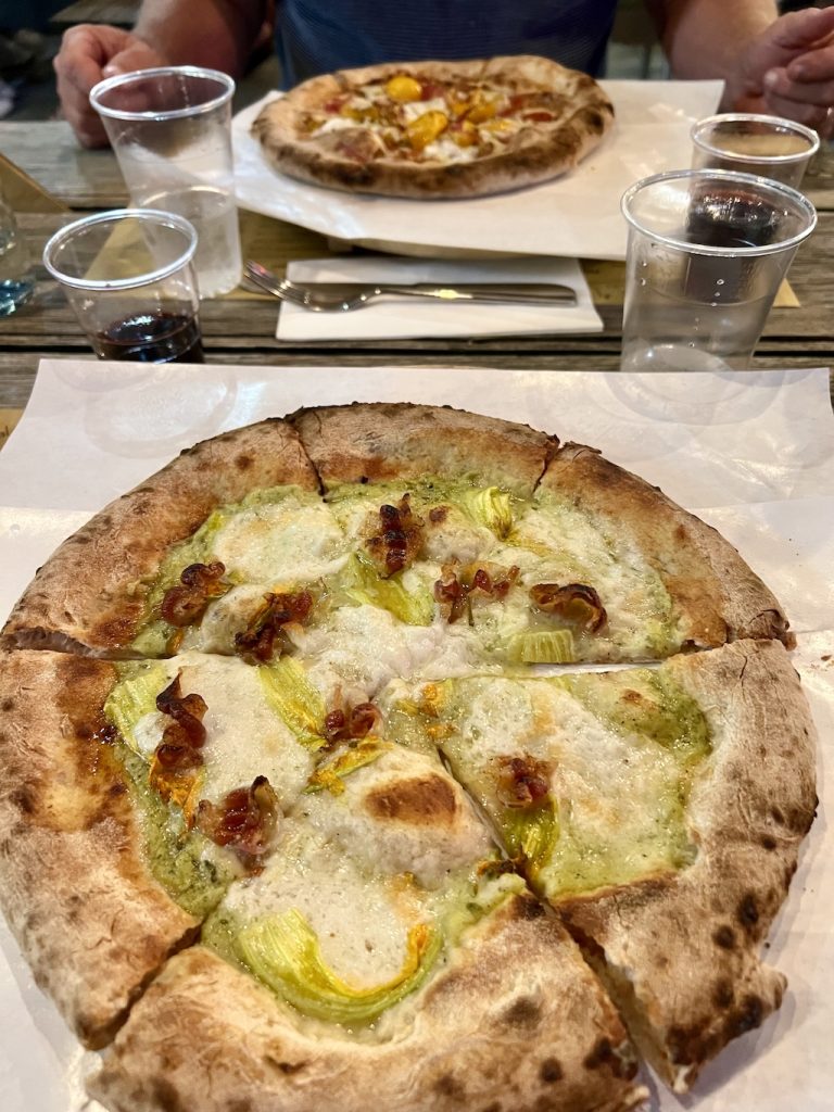 Image of two pizzas on a table.